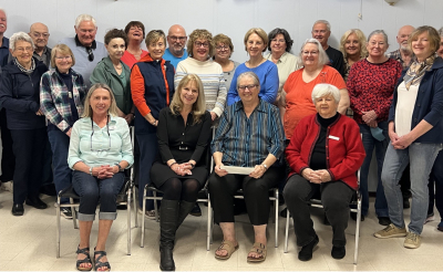 Kemptville Duplicate Bridge Club assembled to donate $1,000 to the CT Scanner Crossroads Campaign. In the front row, seated centre, right, Liz Robinson, club’s president, presents the cheque to Margret Norenberg, KDH Foundation Chair, (seated centre, left).