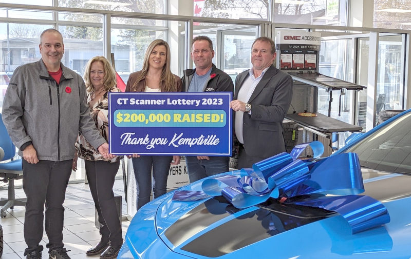 (l-r) Pat Poirier, KDH Foundation Director and Joanne Mavis, Foundation, Executive Director, hold the thank you sign with Bob McVeigh, Myers General Manager, Kemptville (far right). Centre, happy winners of the Grand Prize blue Camaro, Mandy Moodie and Todd Durie.  Todd Durie, (middle) winner of the CT Scanner Lottery Grand Prize, Camaro, is seen here with his partner Mandy, Foundation Executive Director, Joanne Mavis (far left), 
