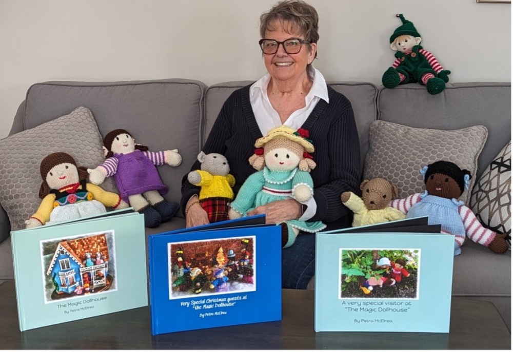 petra surrounded by her hand knit dolls