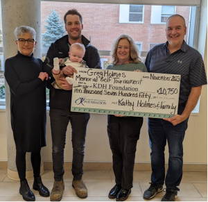 Presenting the cheque from the proceeds of the Greg Holmes Memorial Golf Tournament was (l-r) Kathy Holmes, Brett Holmes holding Tate Holmes, Joanne Mavis, KDH Foundation Executive Director and Pat Poirier, Foundation Director.